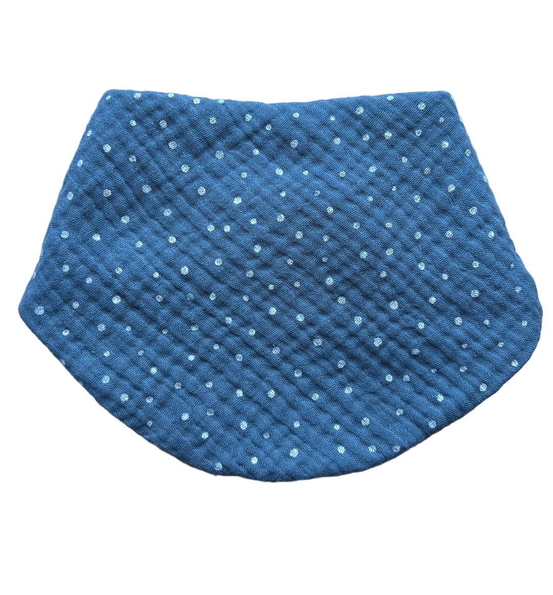 Blue textured pouch with white polka dots on a light gray background